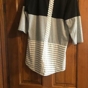 Med black, gray, white cotton shirt, lace on back.